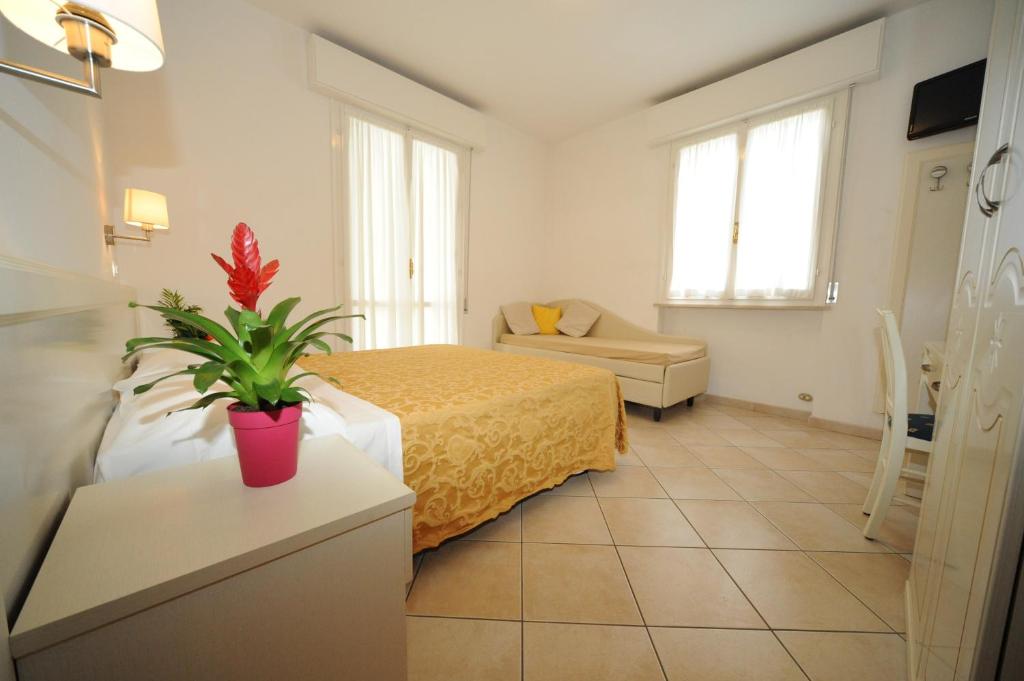 Postel nebo postele na pokoji v ubytování Albergo Villa Aida