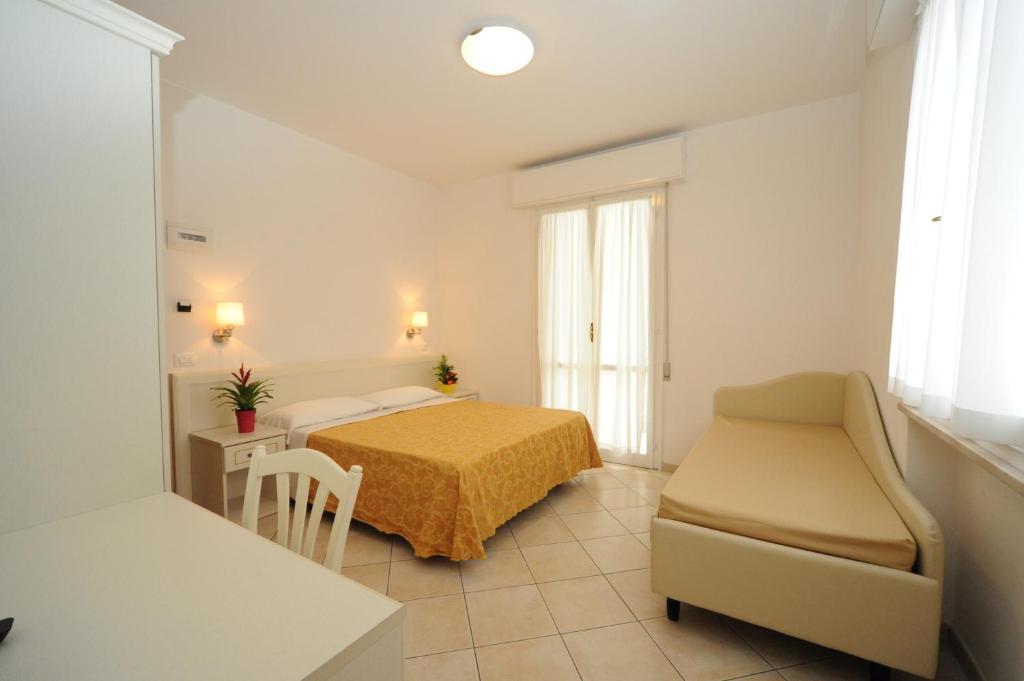 Postel nebo postele na pokoji v ubytování Albergo Villa Aida