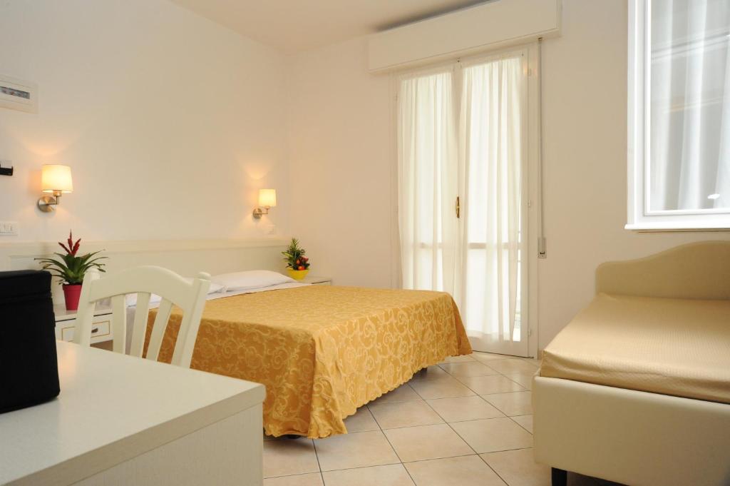 Postel nebo postele na pokoji v ubytování Albergo Villa Aida