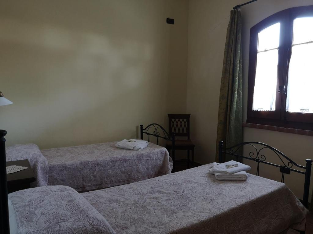 Łóżko lub łóżka w pokoju w obiekcie Agriturismo Catena