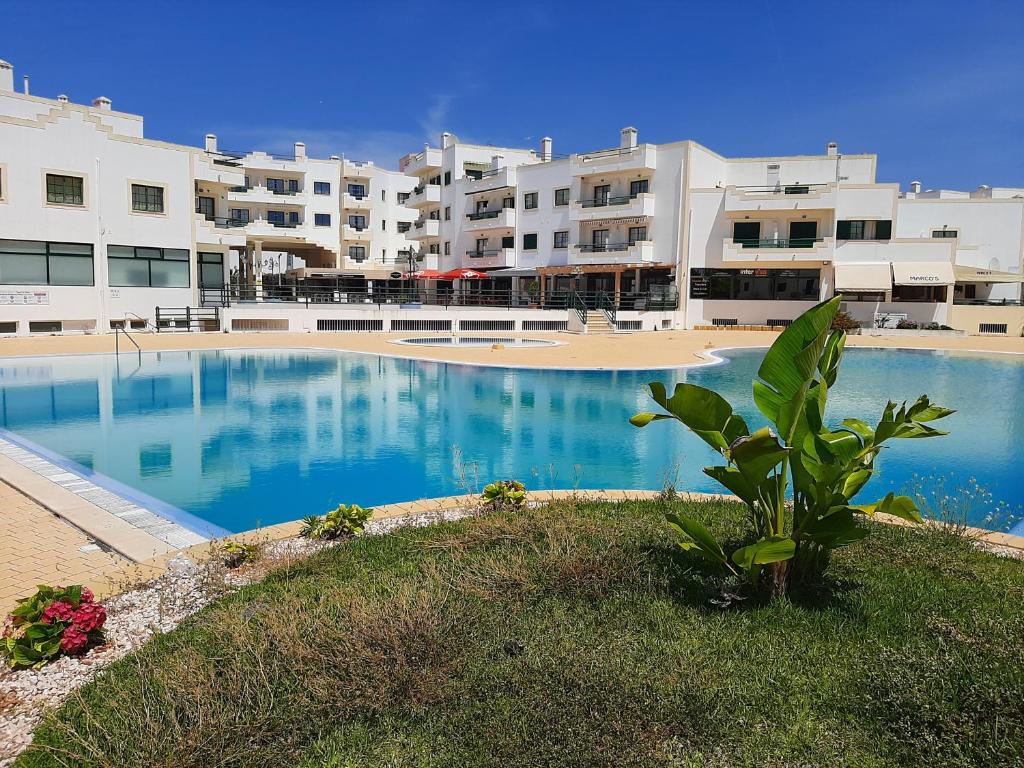 a large swimming pool in front of a building at Dunas do Alvor apartment 146 in Alvor