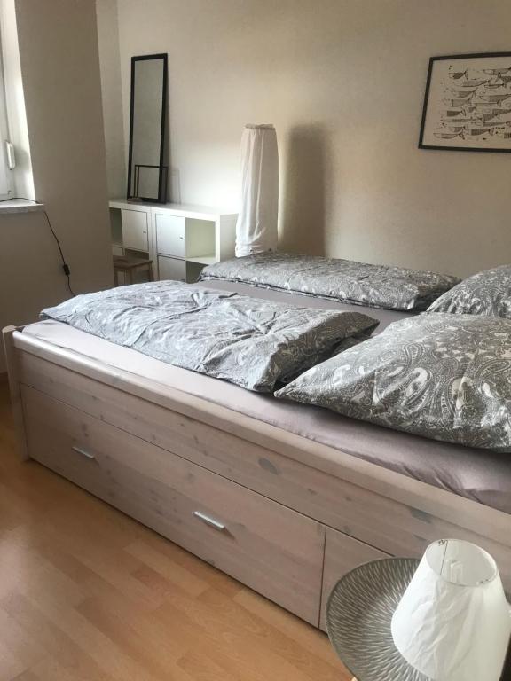 a large bed with a wooden bed frame in a room at Ferienwohnung Am Grünen Band in Rieth