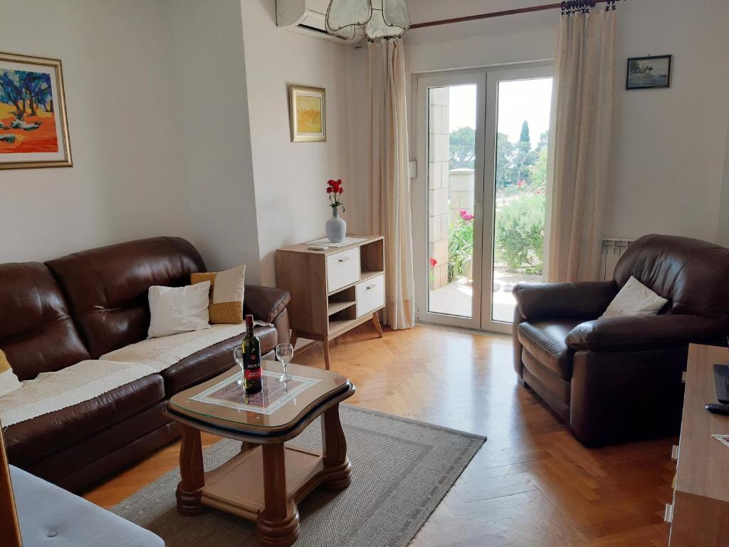 a living room with a couch and a coffee table at Apartments Deranja in Dubrovnik