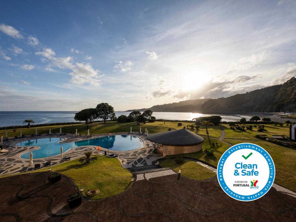 a view of a resort with a pool and the ocean at Pestana Bahia Praia Nature & Beach Resort in Vila Franca do Campo