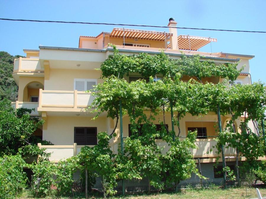 a building with trees in front of it at LEVANDA in Supetarska Draga