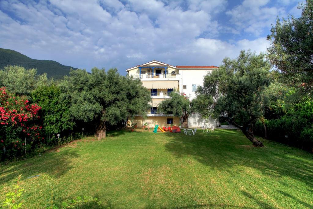 a house with a large yard with trees at The Filoxenia Apartments, Nikiana in Nikiana