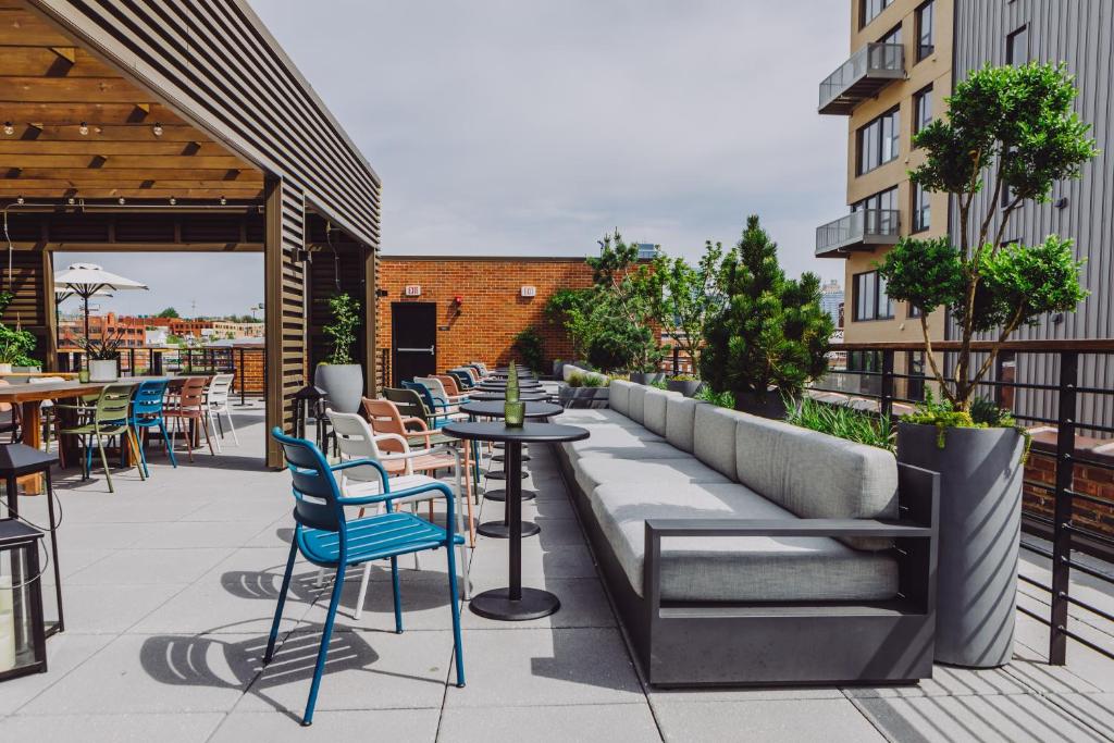 a patio with tables and chairs on a building at Crossroads Hotel in Kansas City