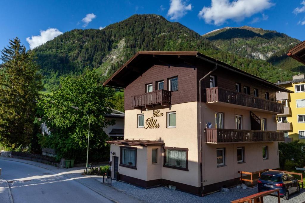 an apartment building with mountains in the background at Haus Piller in Bad Hofgastein
