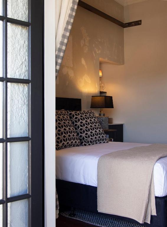 a bedroom with a bed and a window at The Convent Hotel in Auckland
