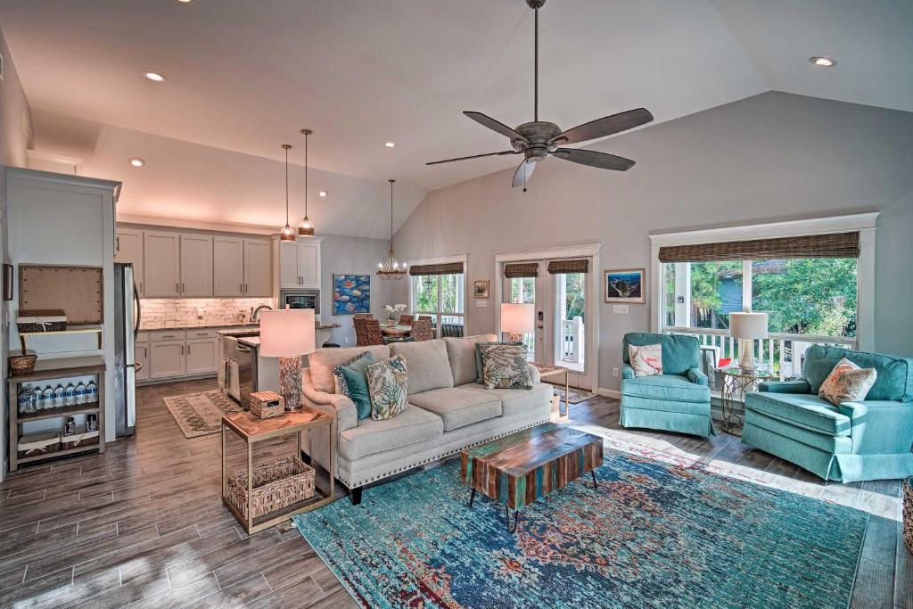 a living room with a couch and a ceiling fan at Quiet Fishermans House with Hot Tub and Tropical Bar! in Dauphin Island