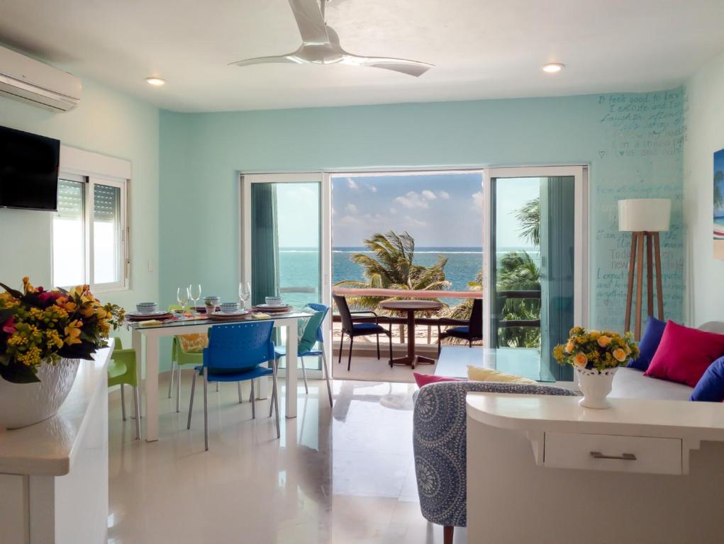 a kitchen and living room with a view of the ocean at Casa Frida in Puerto Morelos