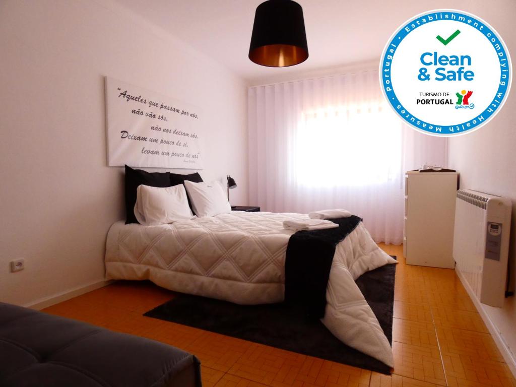 a bedroom with a bed with a sign that says clean and safe at Casa Sandra - Apartamento Mariana in Lousã