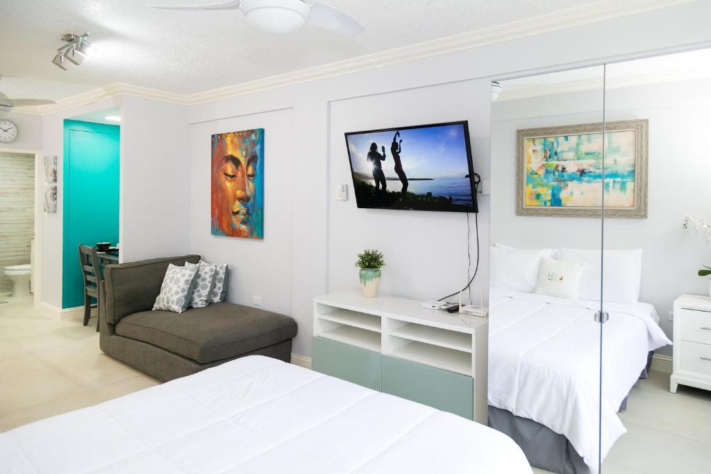 a bedroom with a bed and a chair at Choose To Be Happy at Seymour # 9 and #16 - Studio Apartments in Kingston