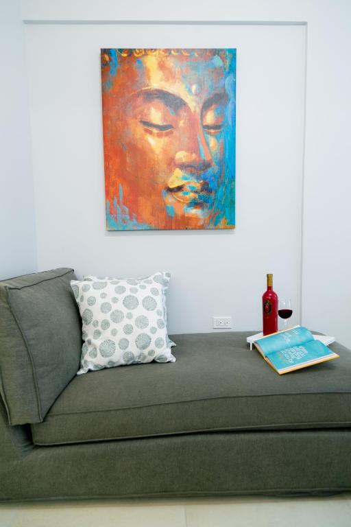 a couch in a room with a painting on the wall at Choose To Be Happy at Seymour # 9 and #16 - Studio Apartments in Kingston