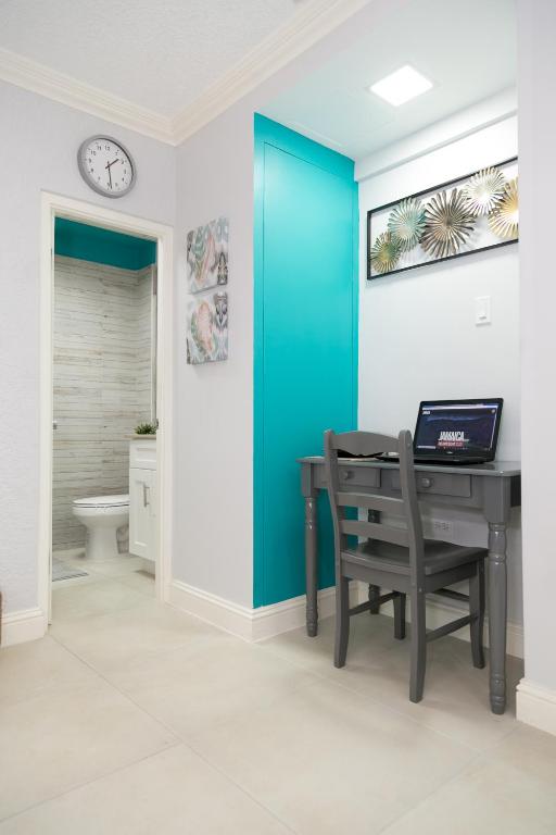 a room with a desk with a laptop on it at Choose To Be Happy at Seymour # 9 and #16 - Studio Apartments in Kingston