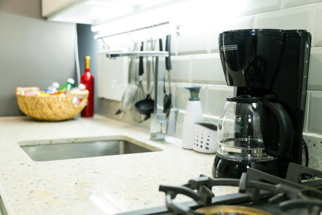 a kitchen counter with a coffee maker on a counter top at Choose To Be Happy at Seymour # 9 and #16 - Studio Apartments in Kingston