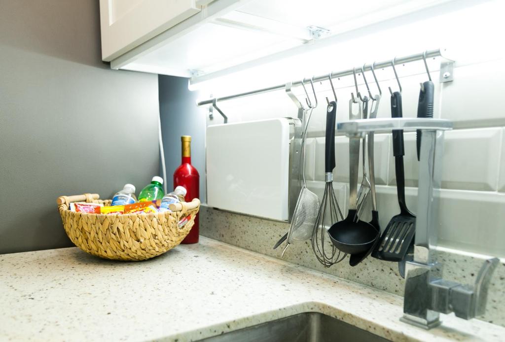 a kitchen counter with a basket of food and utensils at Choose To Be Happy at Seymour # 9 and #16 - Studio Apartments in Kingston