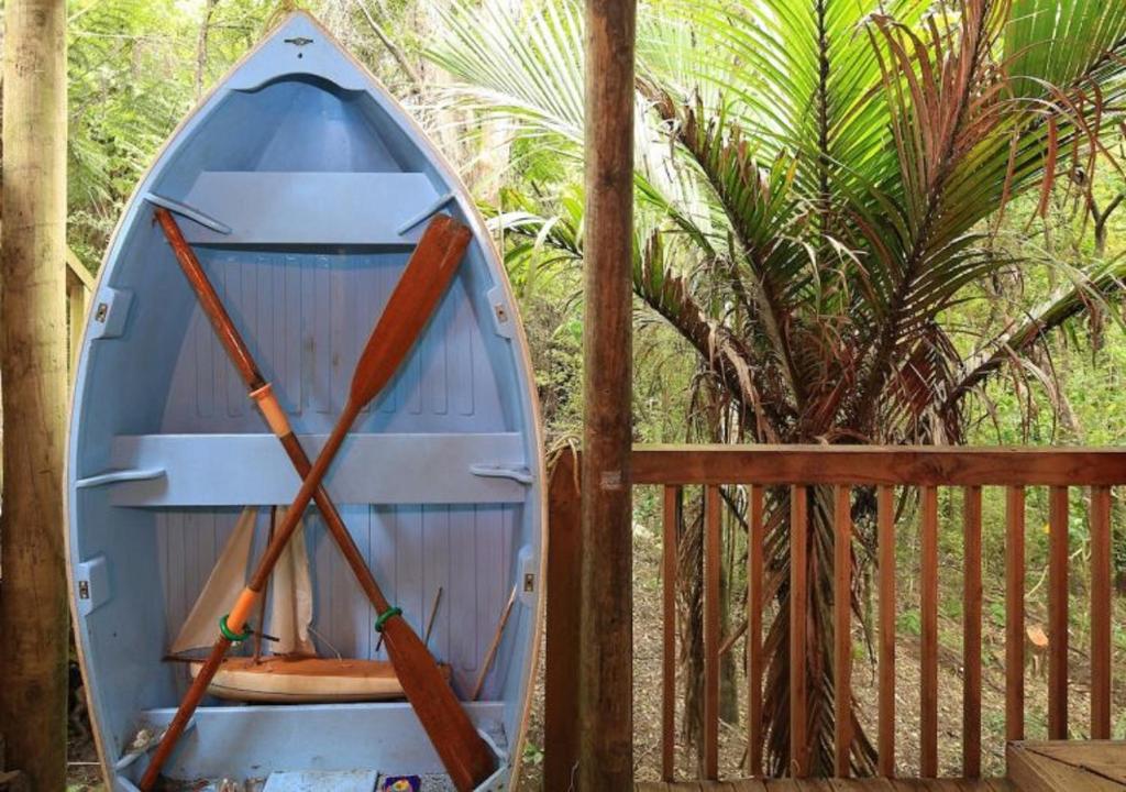 a blue boat sitting next to a fence at Waiheke Escape in Palm Beach