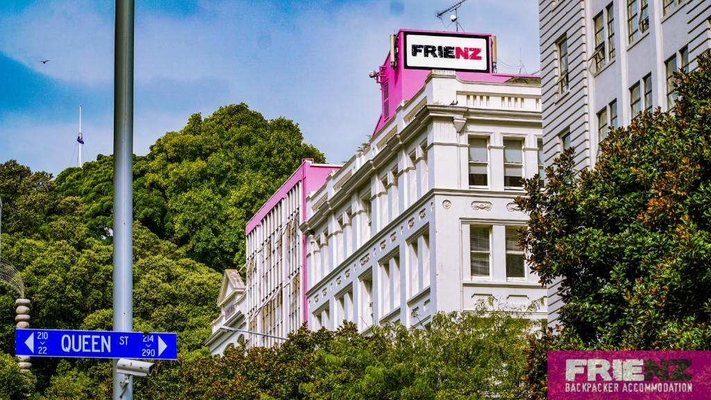 a white building with a sign on top of it at Frienz Backpacker in Auckland