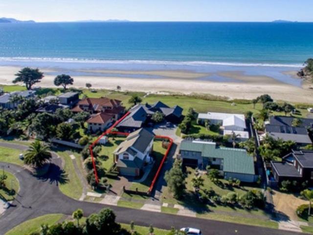 an aerial view of a house near the beach at Kiwi Kuta with direct beach access -Matarangi Home in Matarangi