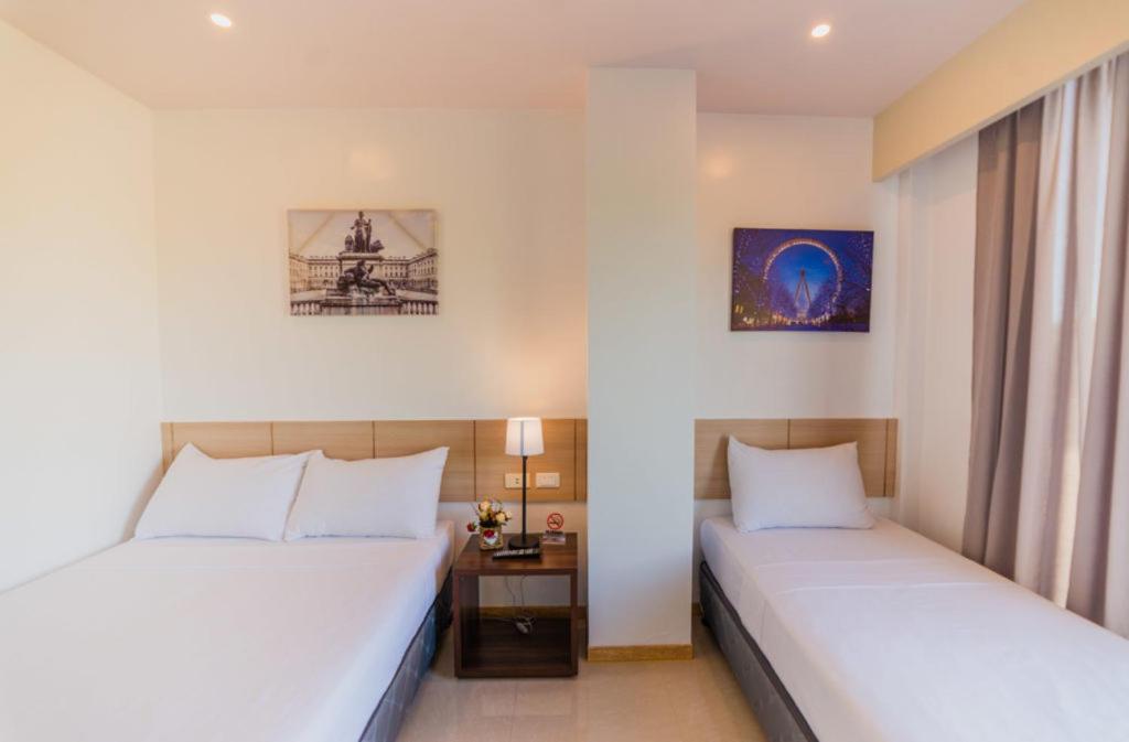 A bed or beds in a room at Soi Suites