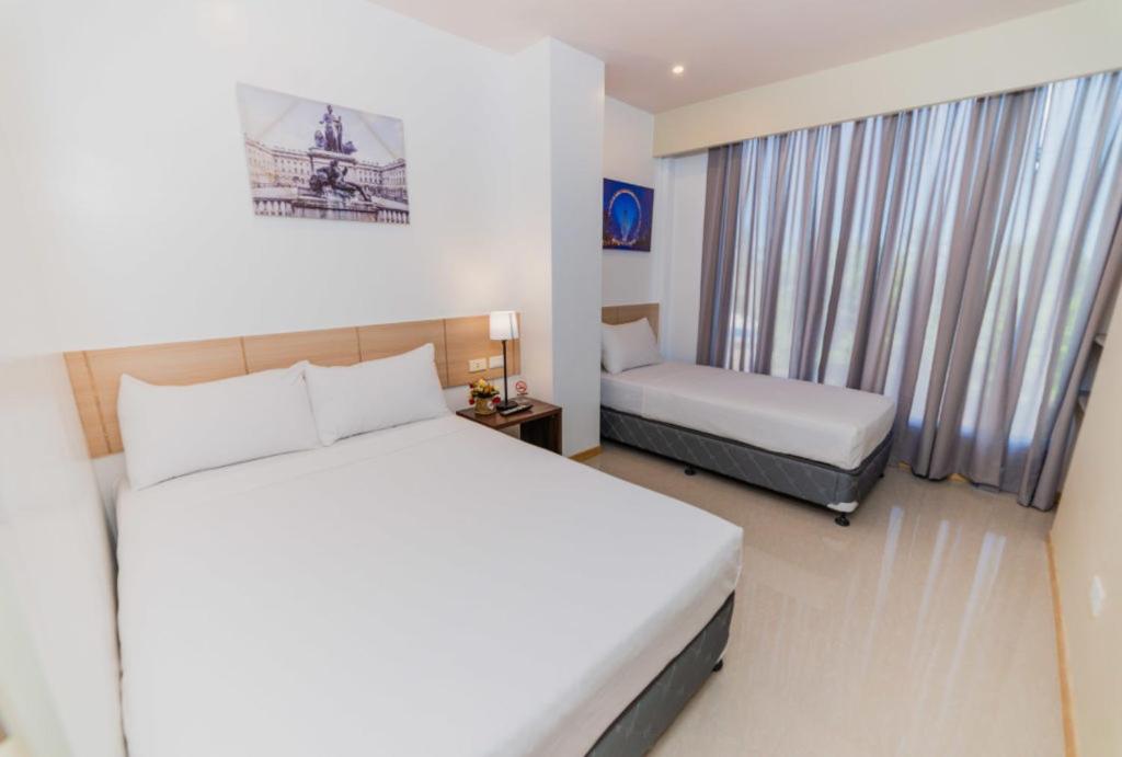 Postel nebo postele na pokoji v ubytování Soi Suites