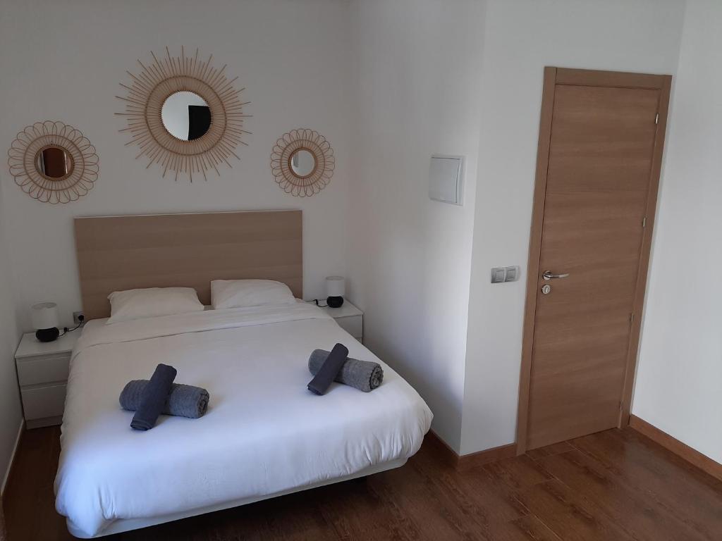 a bedroom with a white bed with two pillows on it at New Apartment & Parking Alcazaba in Málaga