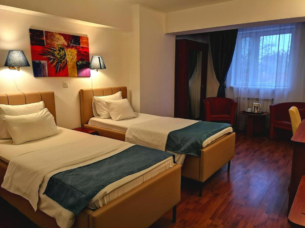Postel nebo postele na pokoji v ubytování Atrium Hotel Bucharest City Center