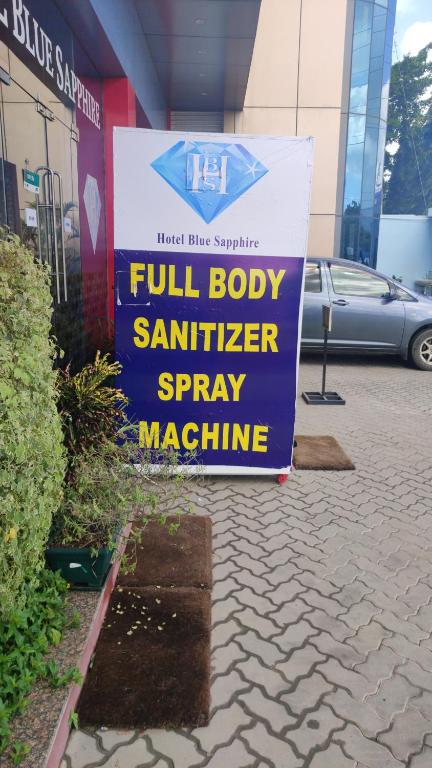 a sign for a full body sanitizer sprinkler spray machine at Hotel Blue Sapphire in Dar es Salaam