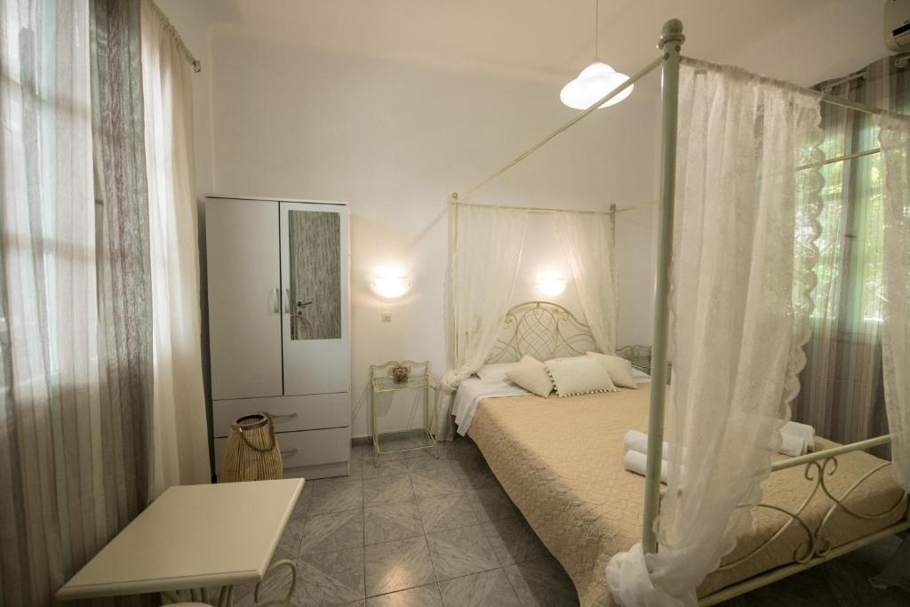 a bedroom with a bed with a canopy at Vithos in Agnontas