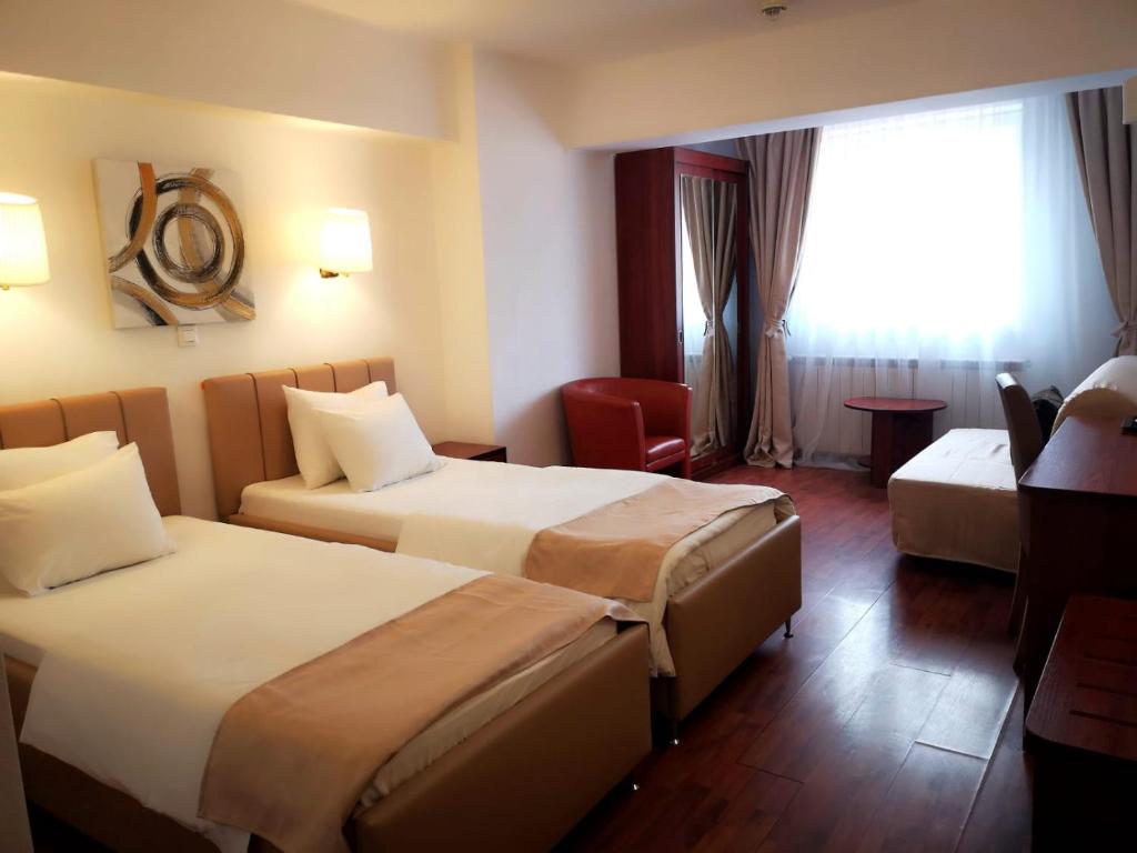 Postel nebo postele na pokoji v ubytování Atrium Hotel Bucharest City Center