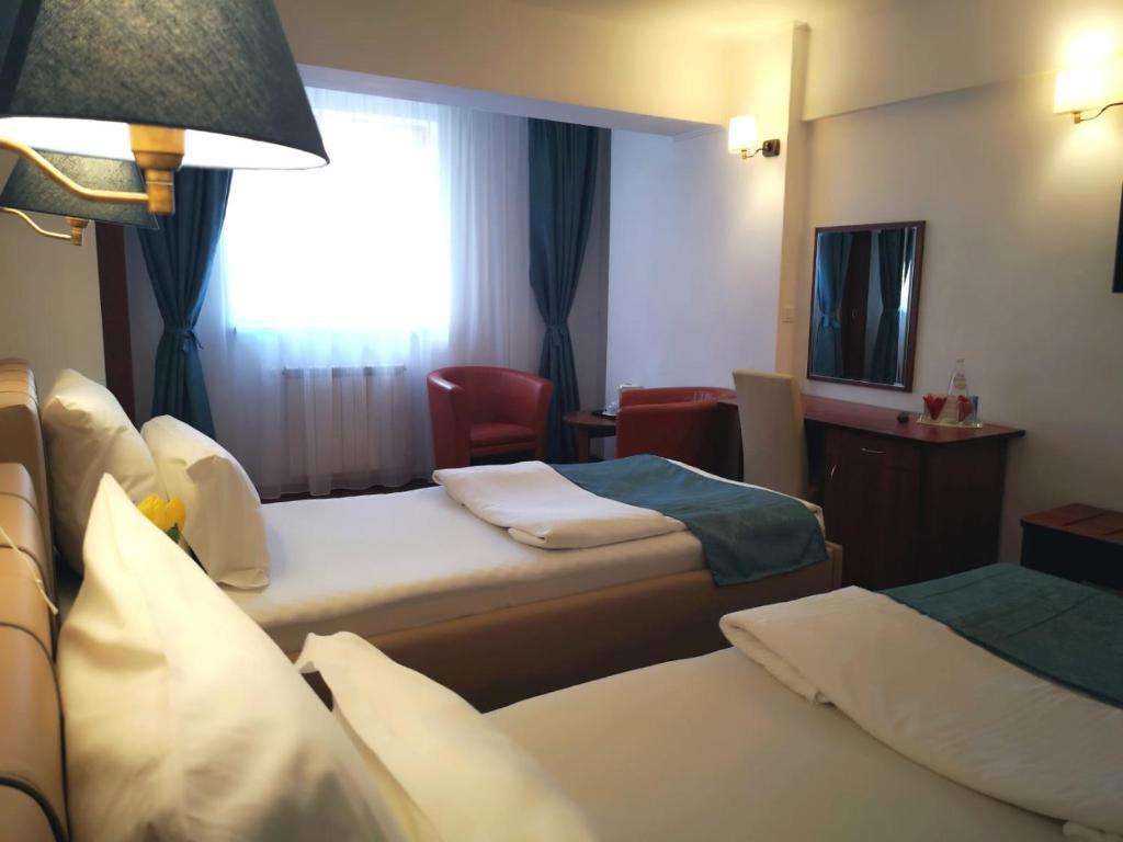 Postel nebo postele na pokoji v ubytování Atrium Hotel Bucharest City Center