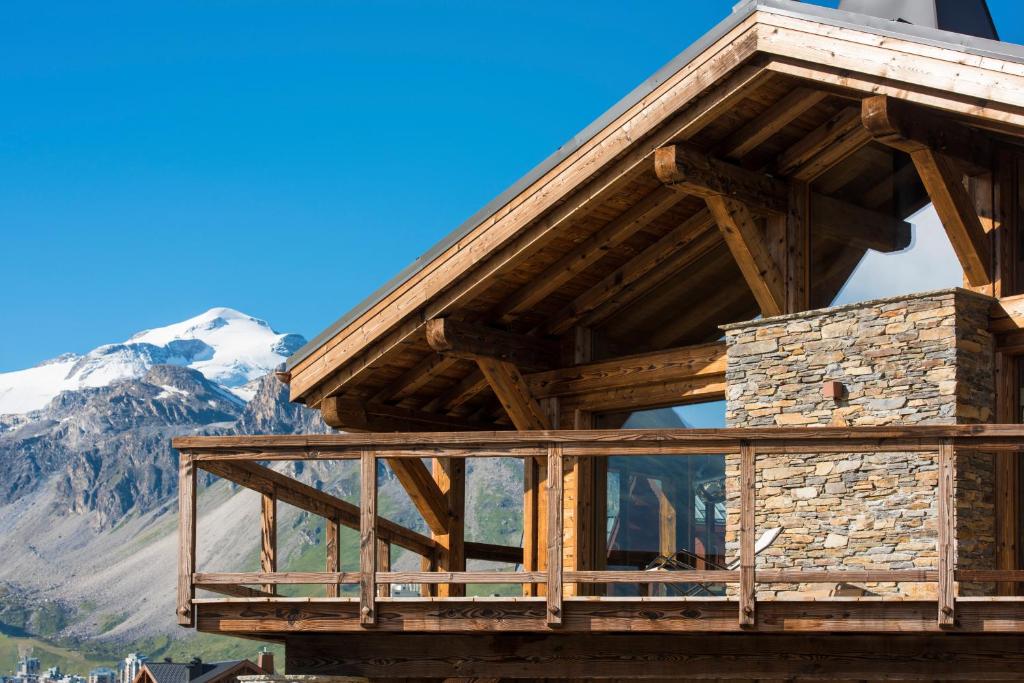 a wooden building with a mountain in the background at Chalet Opale in Tignes