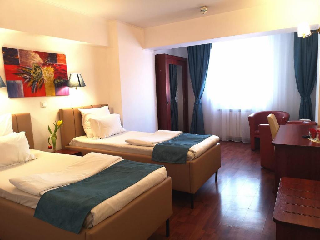Postel nebo postele na pokoji v ubytování Atrium Hotel Bucharest City Center