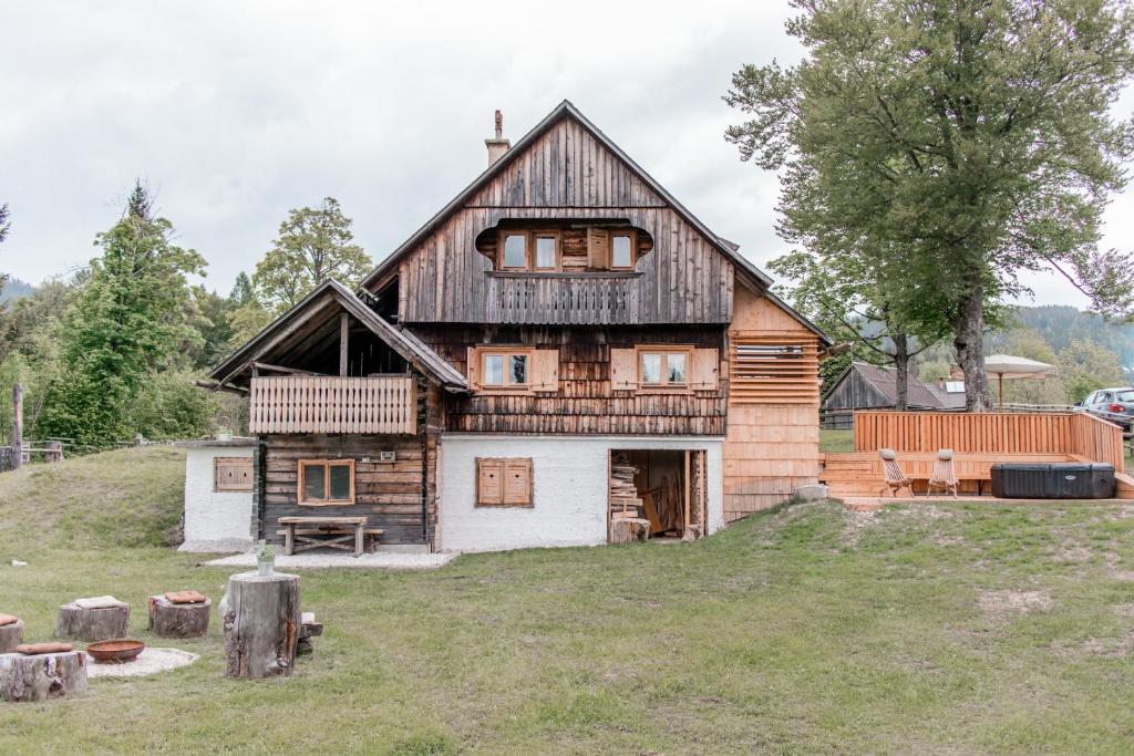 a large wooden house on top of a field at Holiday House Franc in Srednja Vas v Bohinju