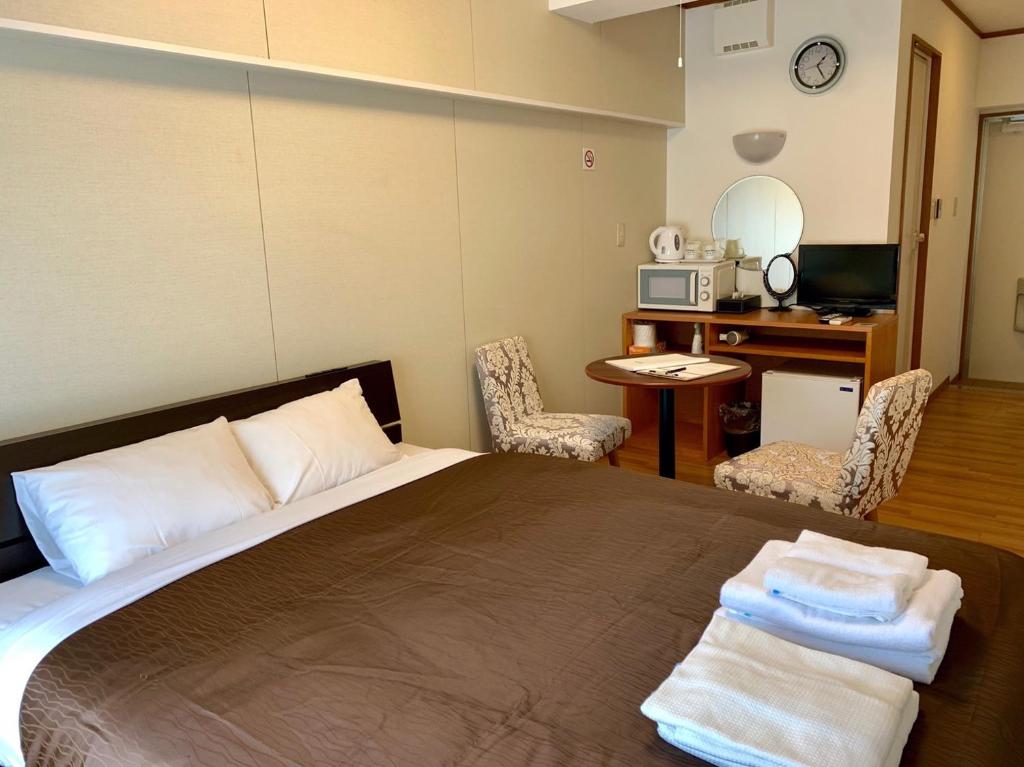 Postel nebo postele na pokoji v ubytování Y' RISE TO HOTEL Miyakojima