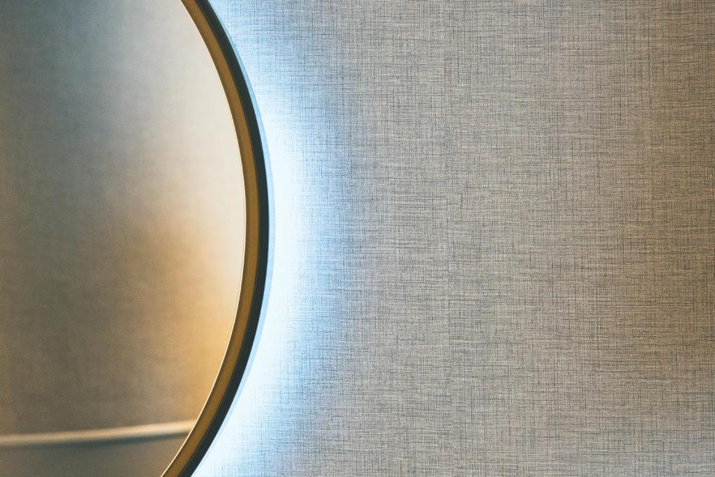 a mirror on the side of a wall at Point A Hotel London Paddington in London