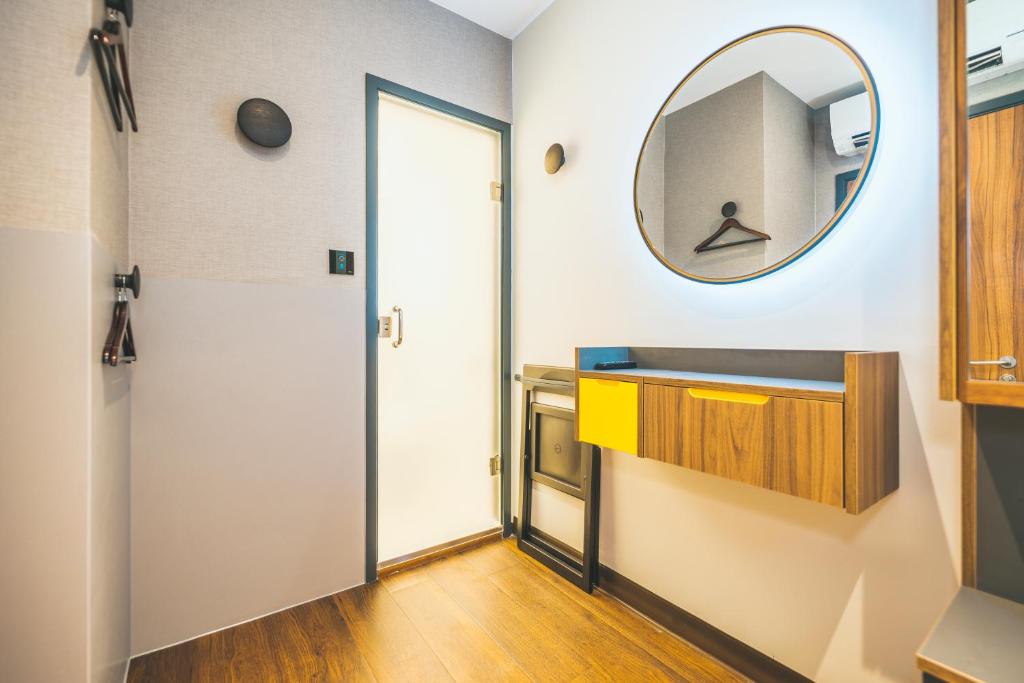 a bathroom with a mirror and a sink at Point A Hotel London Paddington in London