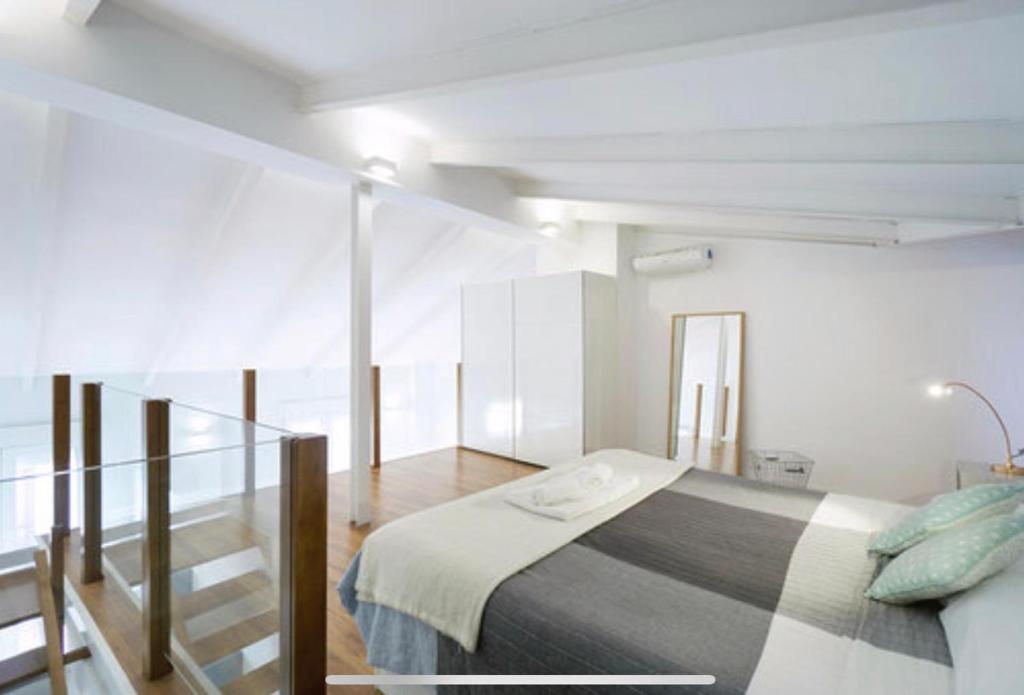 A bed or beds in a room at Pastor Design Suites