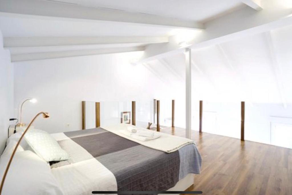 A bed or beds in a room at Pastor Design Suites