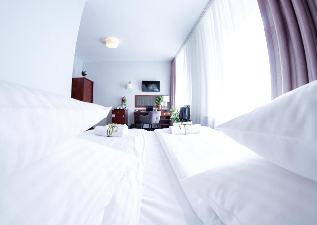 Posteľ alebo postele v izbe v ubytovaní City Center Rooms Piotrkowska 91