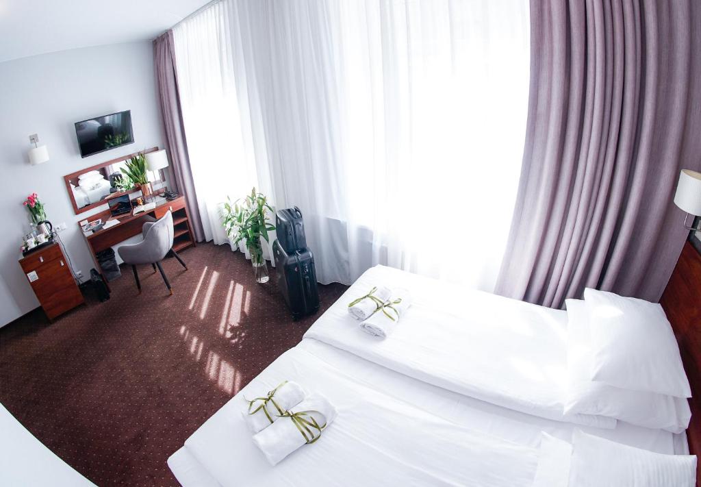 Posteľ alebo postele v izbe v ubytovaní City Center Rooms Piotrkowska 91