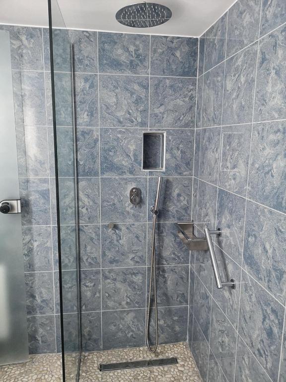 a bathroom with a shower with a glass door at Haraki Village in Haraki