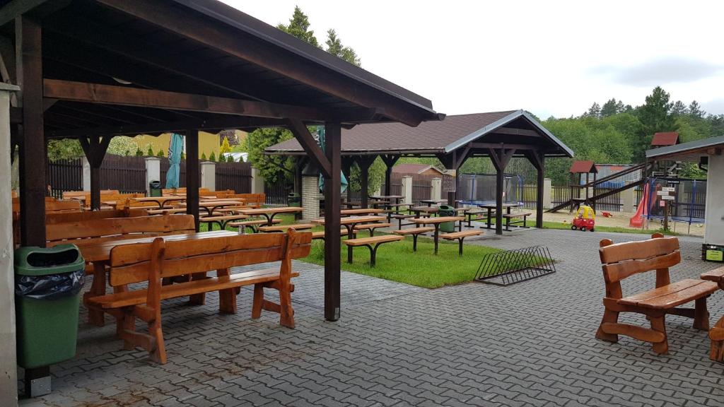 a group of benches and picnic tables in a park at Hotel U Jelena in Havířov