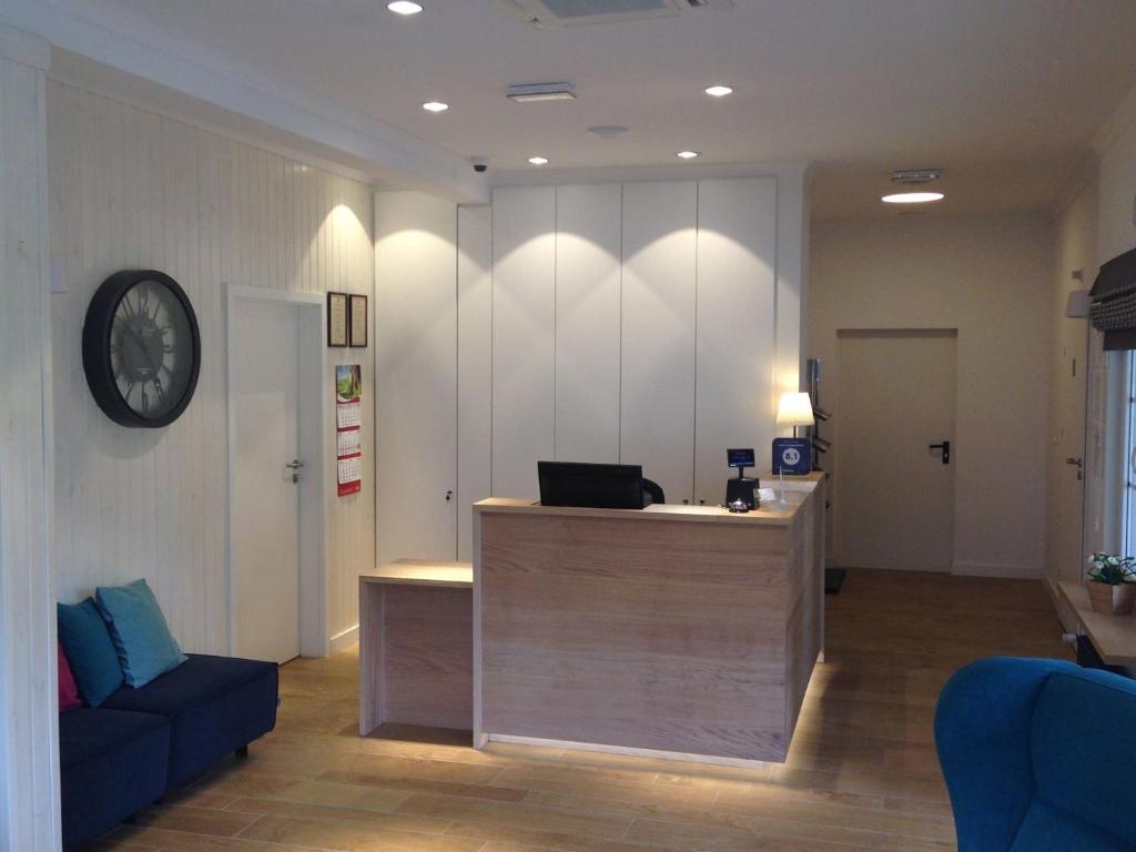 a lobby with a reception desk with a laptop on it at Hotel Camping Malta in Poznań