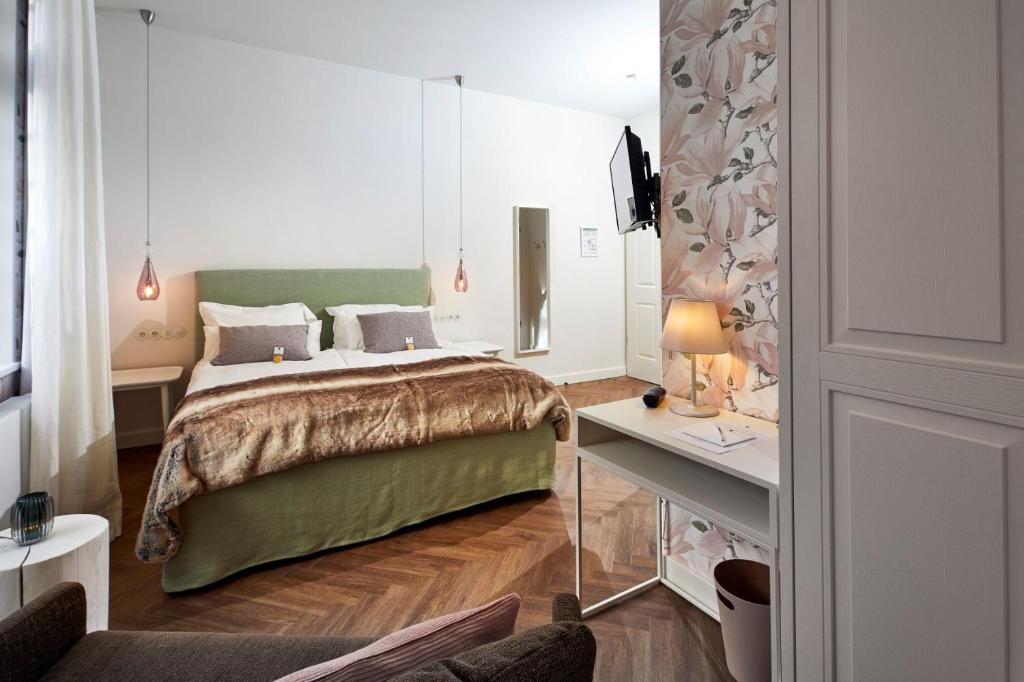 Postel nebo postele na pokoji v ubytování BUITERLING Hotel