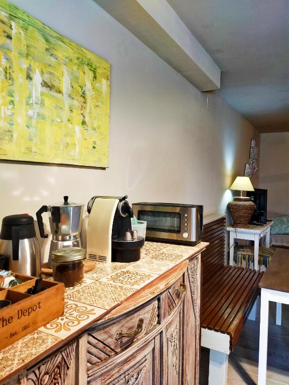 a kitchen with a counter top with a microwave at Casa Francesca Altea piscina y aparcamiento privado in Altea
