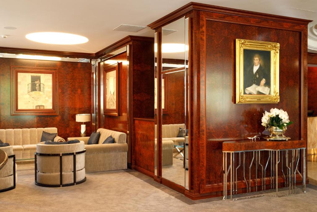 a living room with wood paneling and a room with a couch at Haffner Hotel & SPA Sopot - Destigo Hotels in Sopot