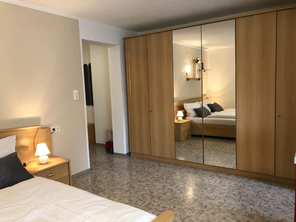 a bedroom with a bed and a large mirror at Ferienwohnung EG Familie Meinschad in Rietz