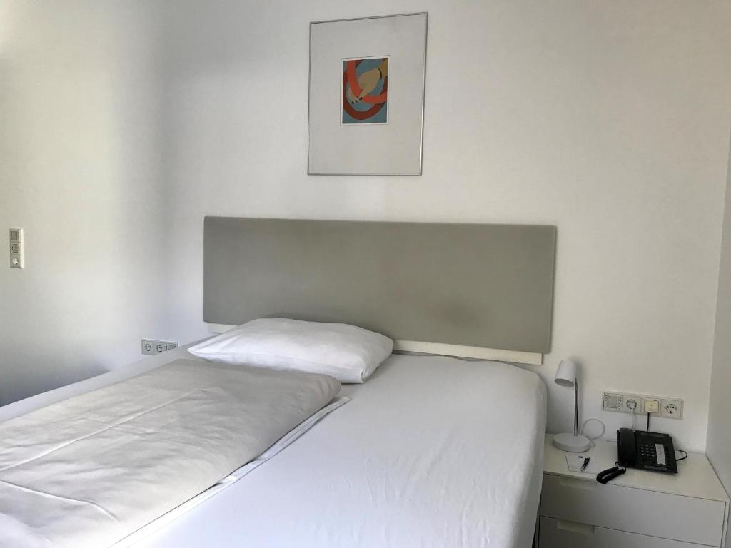 Postel nebo postele na pokoji v ubytování Parkhotel Hall in Tirol